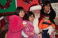 Many children took turns on Santa's lap to tell him what they want for Christmas.  