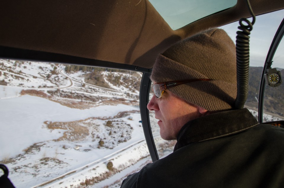 Aran Johnson keeps a sharp eye on the landscape below for elk herds.
