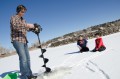 Thumbnail image of Southern Ute Wildlife Technician Jon Broholm punches out fishing holes with the gasoline-powered ice auger.