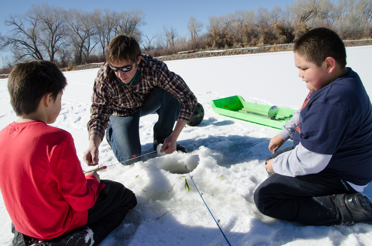 Jon Broholm gives ice-fishing instructions.