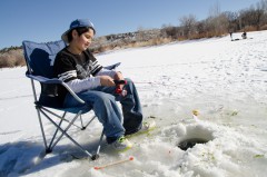 Dustin Sanchez takes in the afternoon with a close watch on his line as his class ice-fishes on Scott’s Pond.