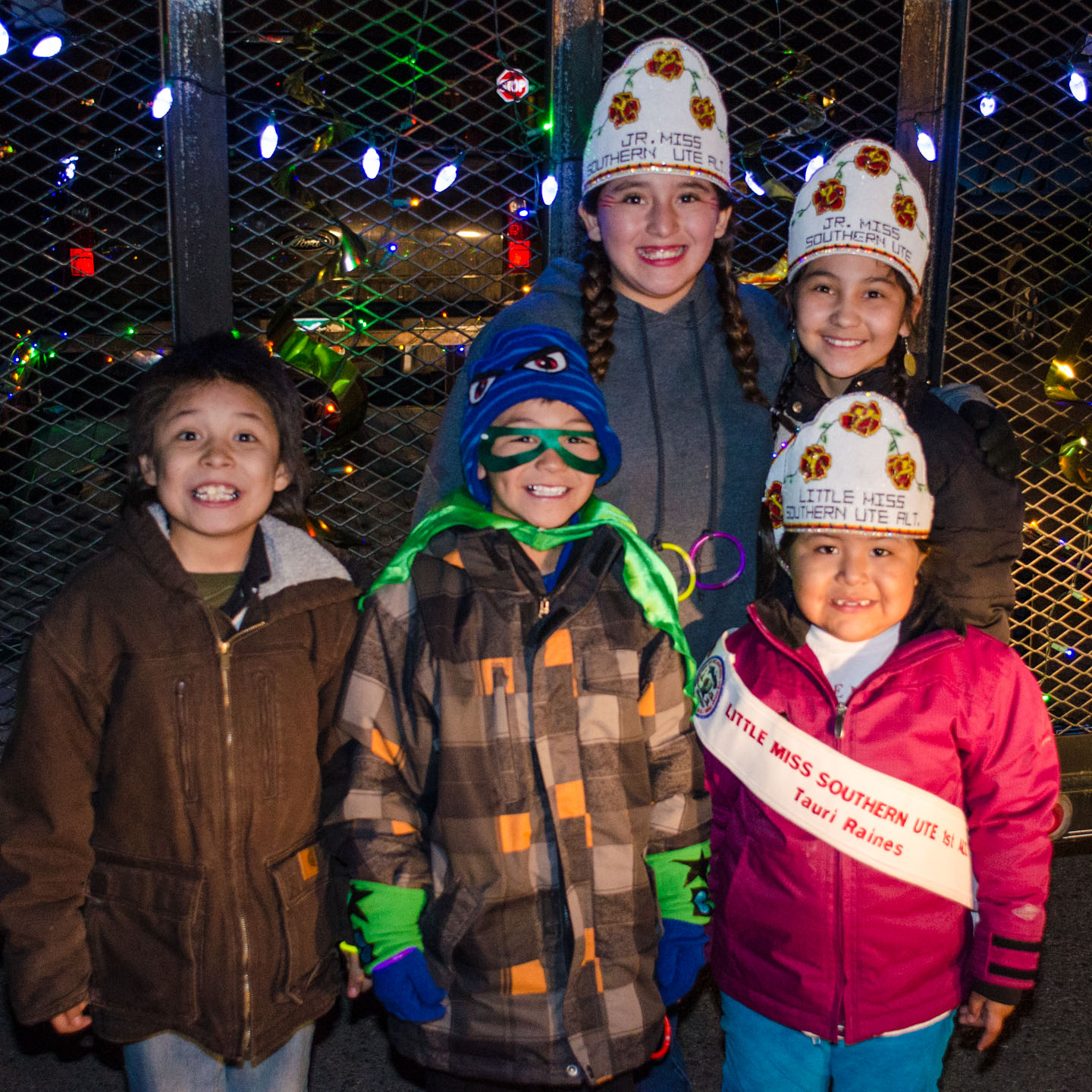 Members of the Southern Ute Royalty bundle up against the cold night.