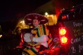 Thumbnail image of Sombrero and poncho help to keep a woman warm.