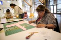 Thumbnail image of Marge Barry was among the participants carefully cutting patterns out of cloth.