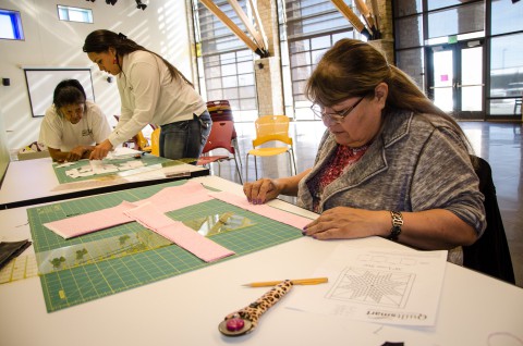 Marge Barry was among the participants carefully cutting patterns out of cloth.
