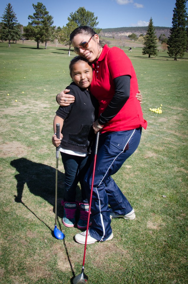 Emily McDonald gives a warm embrace to young Sara Chakee on the green.