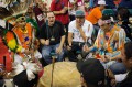 Thumbnail image of Dancers play double duty, sitting in on one of the many drums that resounded throughout the weekend-long powwow