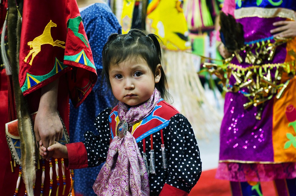 The youngest of the dancers holds close to family during the dance.