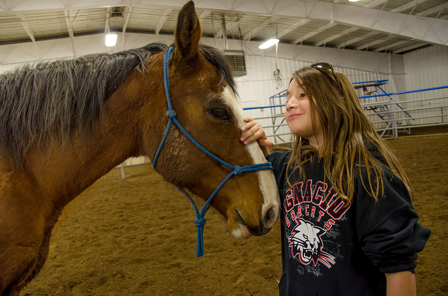 Isabella Torres familiarizes herself with a friendly and gentle horse named Rocky.