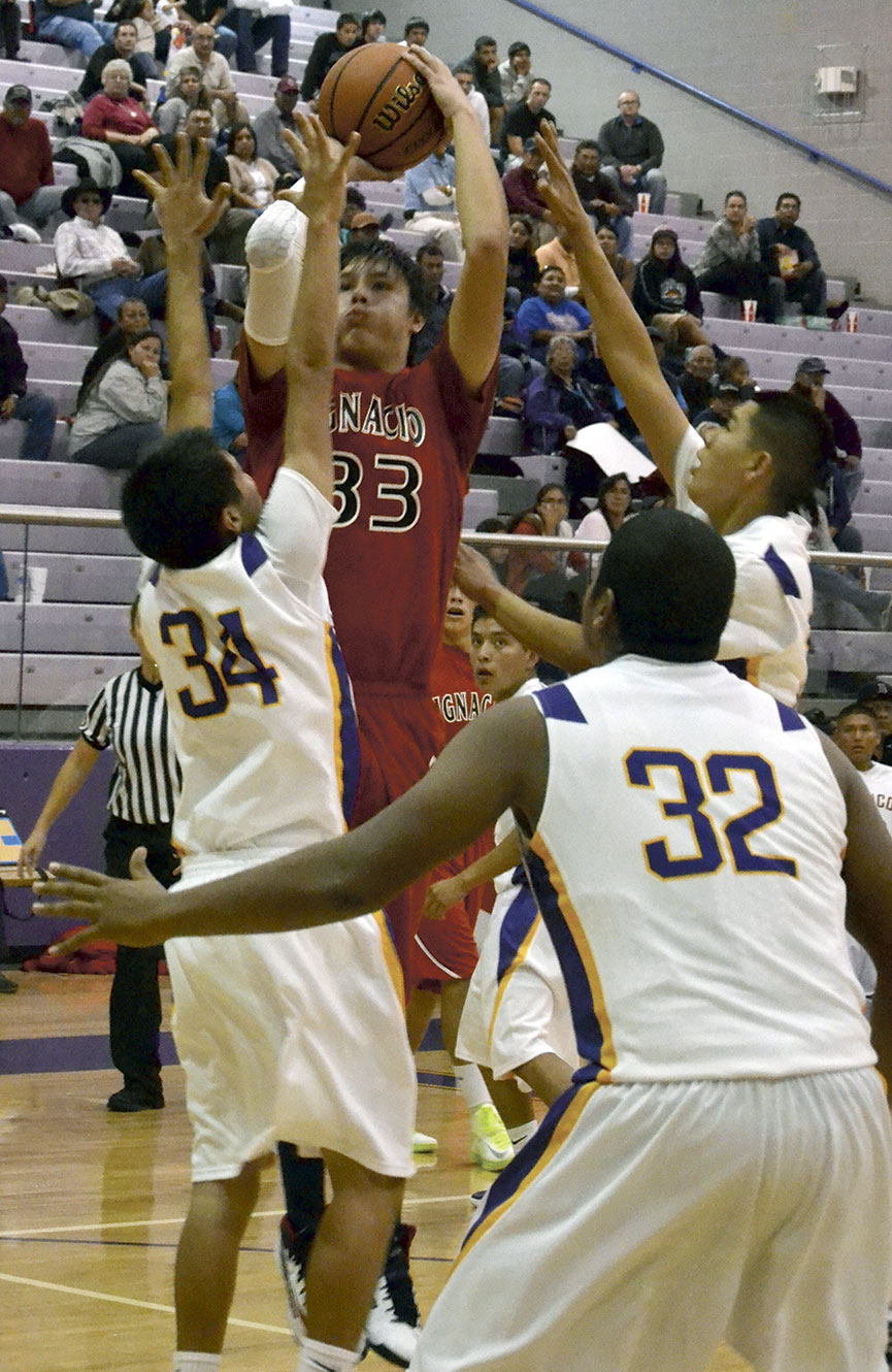 Ignacio forward Adison Jones (33) keeps his mind on the shot leaving his hand against 4A Kirtland (N.M.) Central