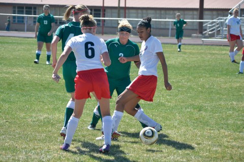 Ignacio's Amya Bison (14) and Tristan Boone (6) try shielding the ball