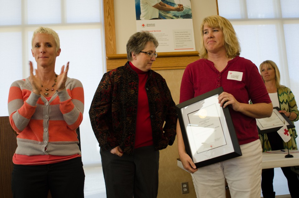 Robin Duffy-Wirth applauds the lifesaving efforts of SunUte Community Center lifeguards who received recognition during the Red Cross Breakfast of Champions.