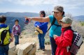 Thumbnail image of Kaycee Jefferson (right), along with her mom Tristian Benally, who points out landmarks on the distant horizon, were among the student group that reached the uppermost Chimney Rock sites.