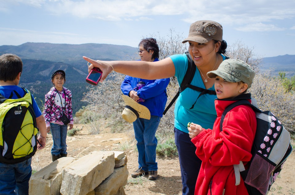 Kaycee Jefferson (right), along with her mom Tristian Benally, who points out landmarks on the distant horizon, were among the student group that reached the uppermost Chimney Rock sites.