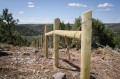 Thumbnail image of The new fenceline cuts a more direct line through rocky, forested areas. Reinforced sections will help to deter livestock. The project is scheduled for completion by the end of June.
