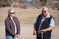 Thumbnail image of Lena Atencio (left), director of the Southern Ute Department of Natural Resources, chats with tribal elder Elwood Kent following a blessing near the site where the department is working to round up feral horses.