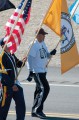 Thumbnail image of Southern Ute veteran Dewitte Baker carries the Southern Ute tribal flag