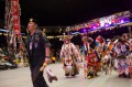 Thumbnail image of A U.S. Army veteran leads a procession on the arena floor.
