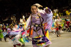Young Southern Ute tribal member Avaleena Nanaeto is a whirl of color during a dance at the University of New Mexico as part of the 30th annual Gathering of Nations Powwow, the largest in North America. 