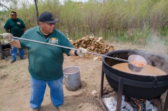 Justin Lang of the Southern Ute Grounds Maintenance Division lends a hand at the Bear Dance Feast on Monday, May 27, the final day of the Southern Ute Bear Dance. A meal of traditional stew, cooked by fire, was served up from a cast-iron kettle outside of the Bear Dance Corral. The home-cooked feast was served with sides of frybread, watermelon and corn on the cob.