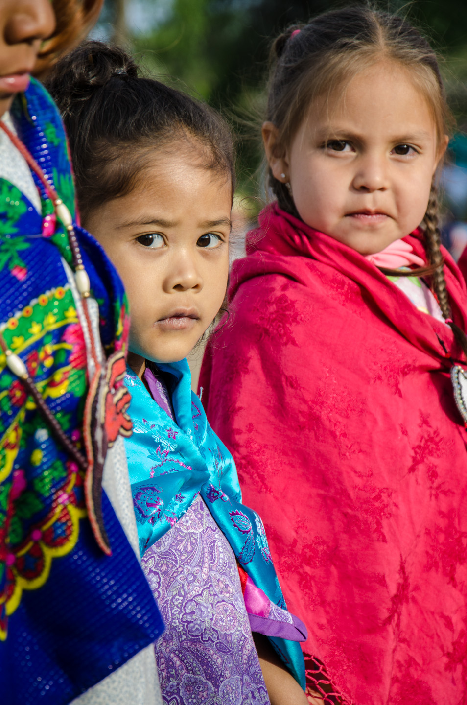 Young dancers stand with practiced patience as they prepare for a line dance with their peers.