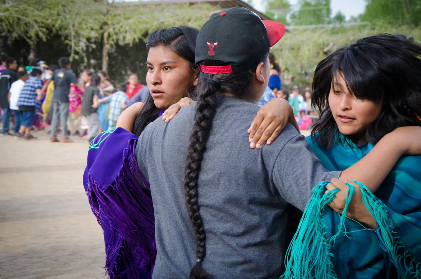 A pair of young women hold their partners tight during the Bear Dance.