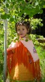 Thumbnail image of Young Southern Ute tribal member Neeka Ryder adorns a traditional dress and shawl for the spring Bear Dance.