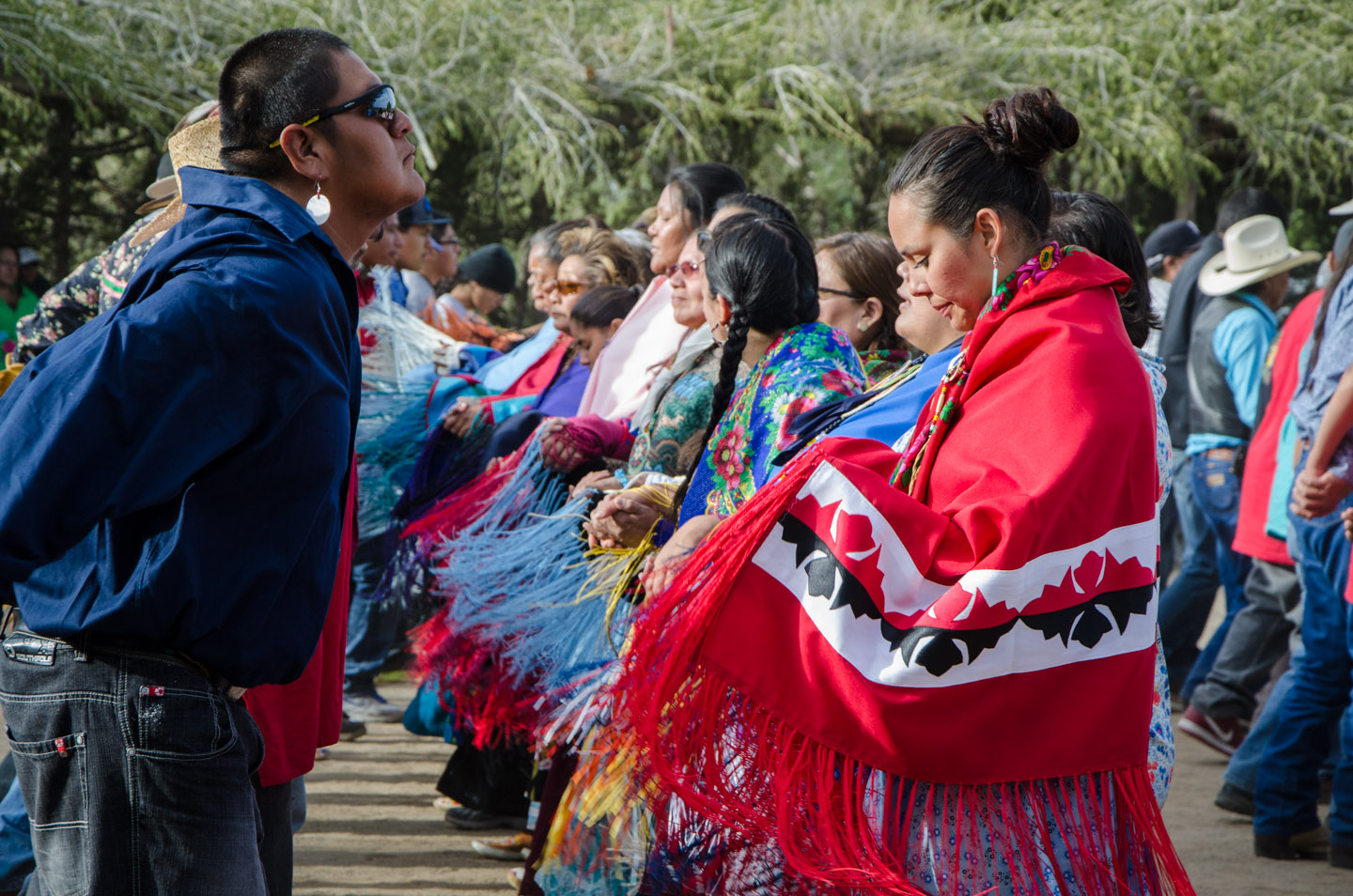 Filling the Bear Dance Corral, couples line dance in a synchronized rhythm, accentuated by the colorful fringes adorning the women’s traditional shawls.