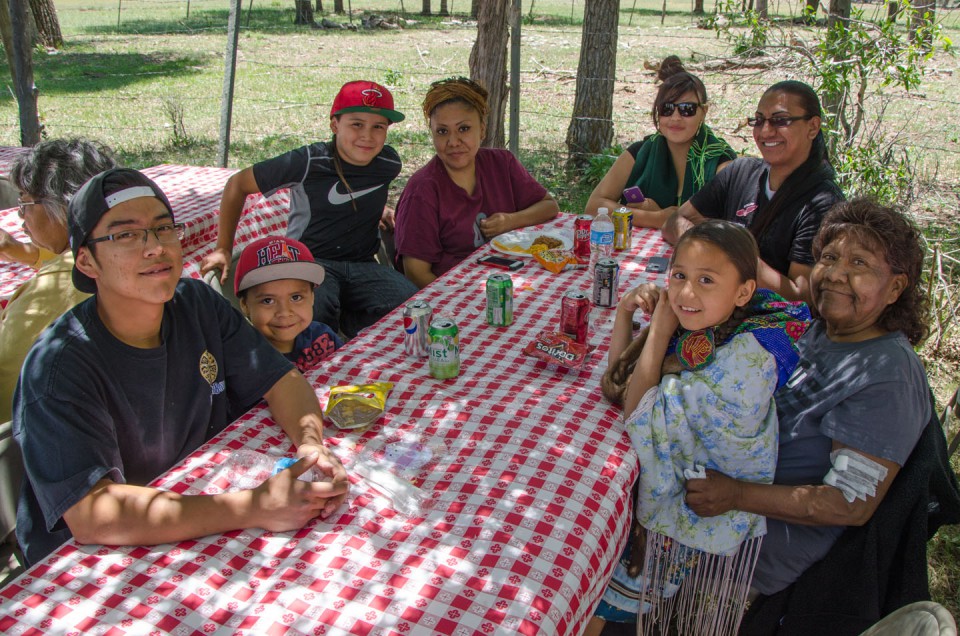 Family members of Debra Watts share food and conversation in the shade during the Bear Dance kickoff lunch, which took place outside of the Bear Dance Corral on Friday, May 24.