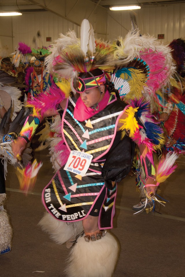 Fancy Dancer Nakwihi Perry dances into the arena during a grand entry at the Southern Ute Bear Dance Powwow.