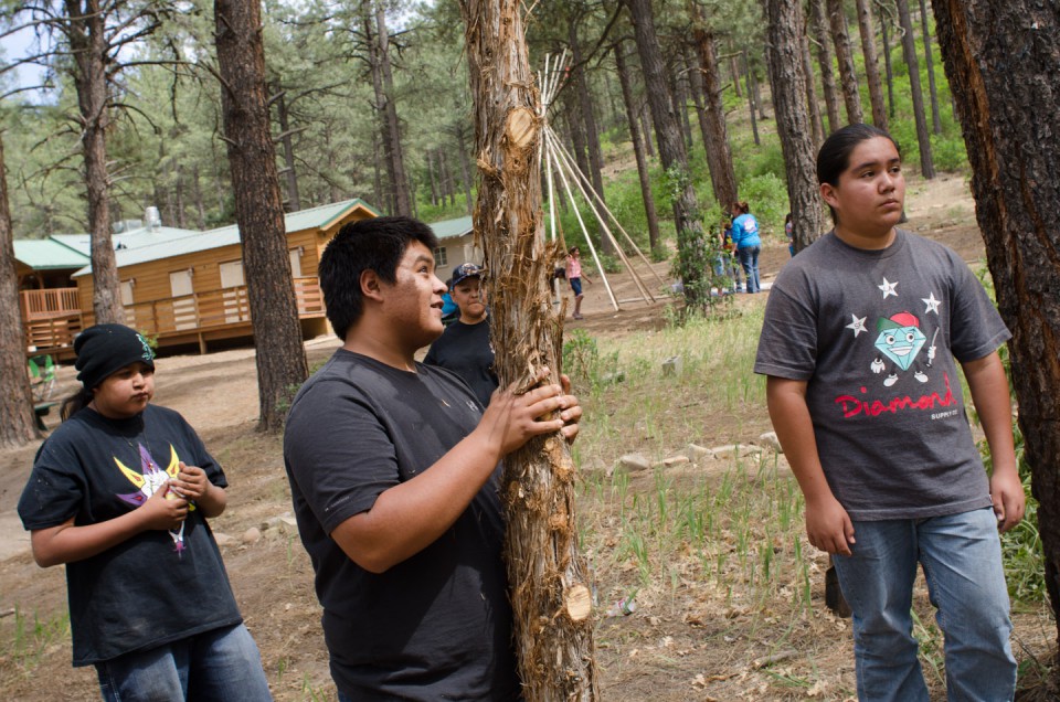 Students work with members of the Southern Ute Woodyard to construct a traditional shade house, highlighting an important cultural activity to the Utes.