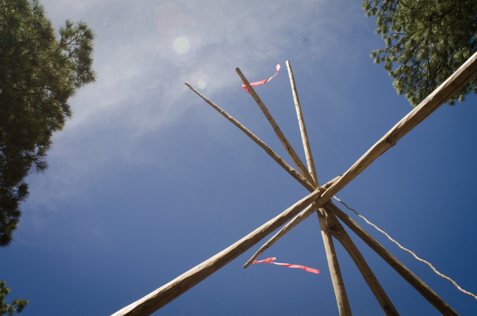 Tipi poles set the frame work for one of the many cultural activities at the weeklong summer youth camp.
