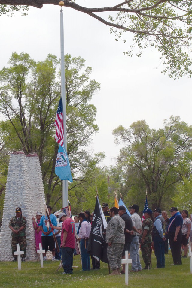 An eagle staff carried by a member of the Leonard C. Burch family and colors of many flags