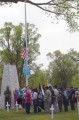 Thumbnail image of An eagle staff carried by a member of the Leonard C. Burch family and colors of many flags