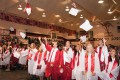 Thumbnail image of Members of the 2013 graduating class of Ignacio High School customarily throw their caps into the air