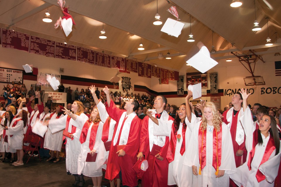 Members of the 2013 graduating class of Ignacio High School customarily throw their caps into the air