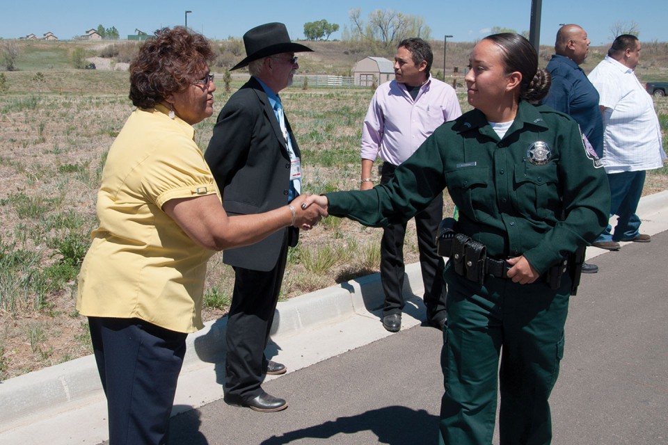 Southern Ute Councilwoman Ramona Eagle shakes hands with Southern Ute Natural Resources Enforcement Ranger Babe Lansing