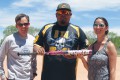 Thumbnail image of SunUte Community Center Recreation Manager Kevin Winkler (left) and 2013 Los Pinos Open Softball Tournament Director Jenn Ruybal (right) present Evan Frost of Team D-12