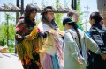 Thumbnail image of Bear Dancers line dance outside of the Southern Ute Cultural Center & Museum during the filming.