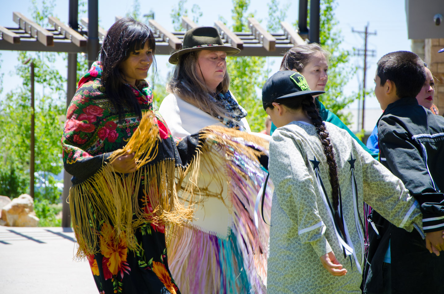 Bear Dancers line dance outside of the Southern Ute Cultural Center & Museum during the filming.