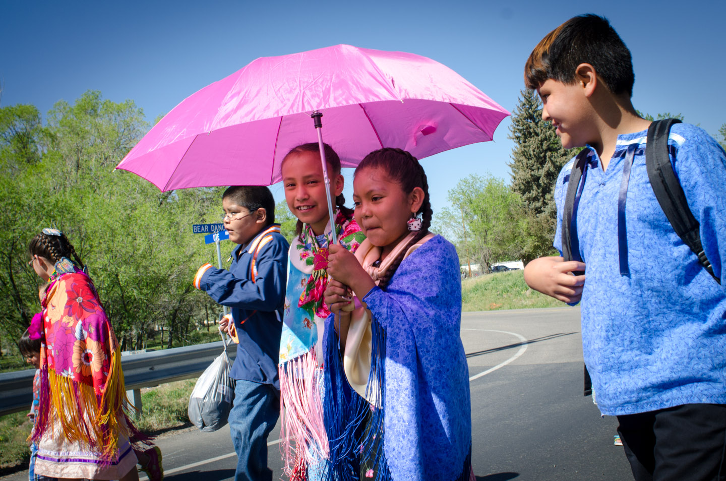 Students from the Southern Ute Indian Montessori Academy make their way down Bear Dance Trail, crossing the Pine River, on Friday, May 24. Joined by members of the Boys & Girls Club of the Southern Ute Indian Tribe, the young dancers got the first dance at the annual Bear Dance.