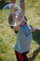 Thumbnail image of A little one reaches for a big bubble.