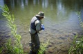 Thumbnail image of Kirk Lashmett, senior water quality specialist for the Southern Ute Indian Tribe’s Water Quality Program, collects samples from the Animas River north of the Florida River confluence for laboratory testing.