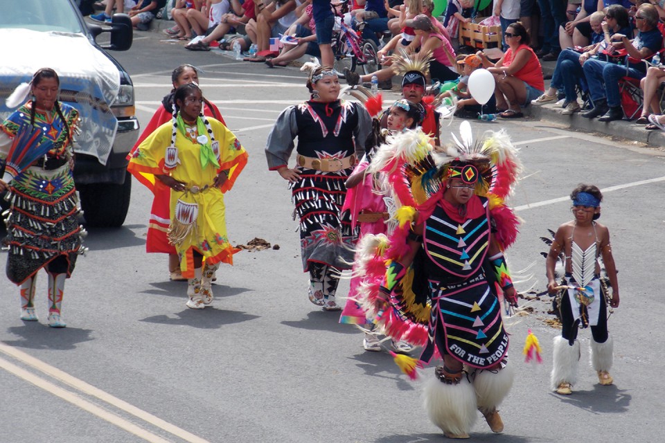 Young members of the Southern Ute Indian Tribe dance down Bayfield’s Mill Street during the town’s annual Fourth of July Parade. Volunteers from the Southern Ute Indian Tribal Council and other organizations also pitched in, handing out fans featuring the tribal seal. More than 3,000 people attended the parade.