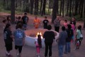 Thumbnail image of Youth and chaperones gather around the fire put for prayers and s’mores on Wednesday, June 26.