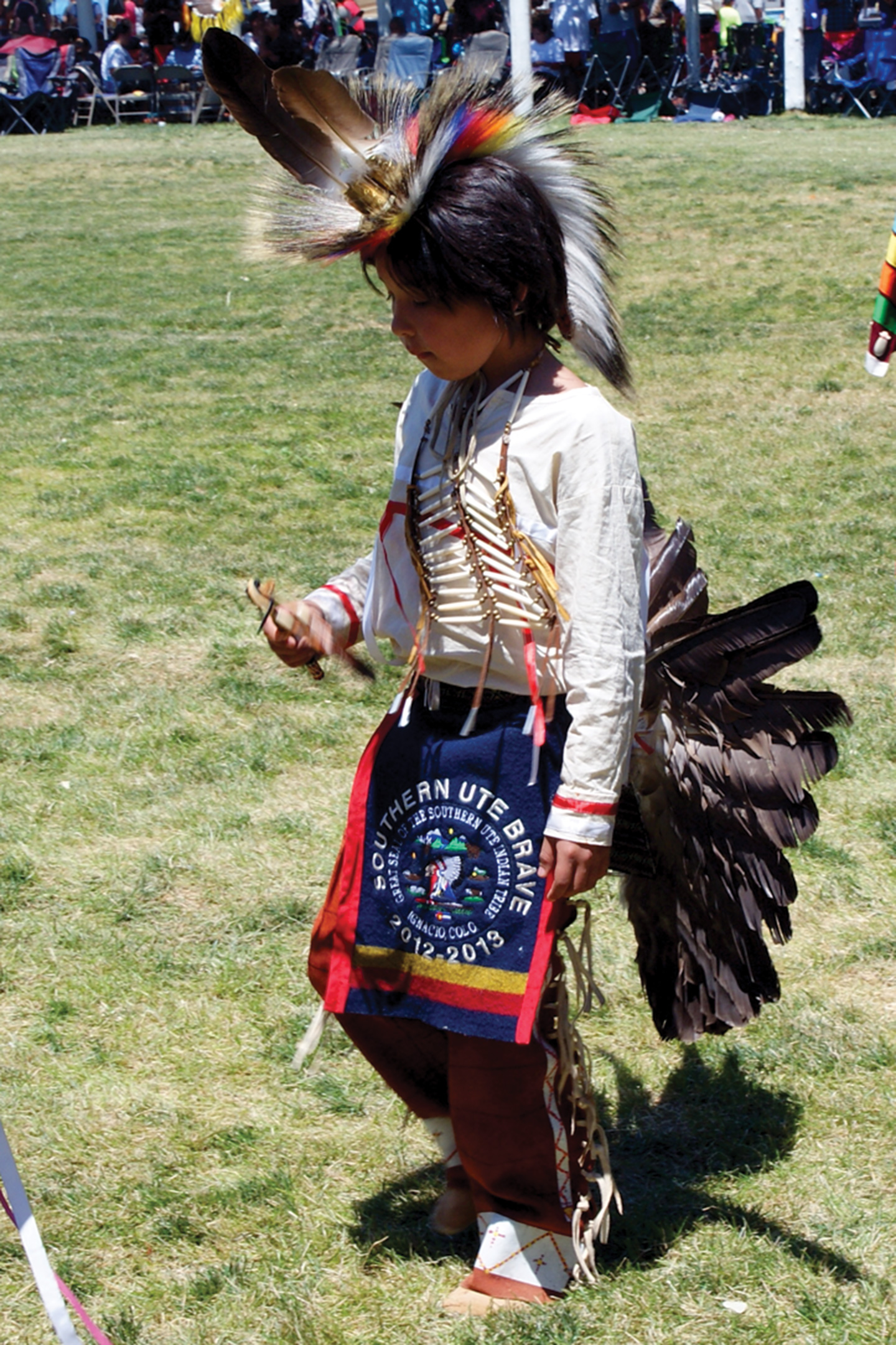 Southern Ute Brave Cyrus Naranjo adorns a traditional bustle.