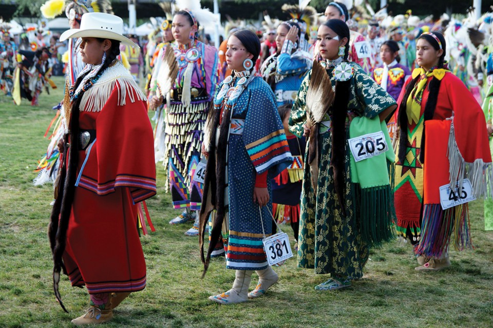 Brianna Goodtracks-Alires (No. 381) dances with others during a grand entry.