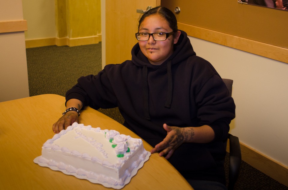 GED recipient Dominika Joy celebrates her accomplishment over cake with friends and family on Tuesday, June 18, in the Mouache-Capote Building. Joy is currently working as a summer Youth Employment Worker with the Boys & Girls Club of the Southern Ute Indian Tribe.