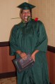 Thumbnail image of GED graduate Hiram House celebrates his graduation with a rose between his teeth before taking a bow.