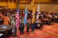 Thumbnail image of Representatives from each tribe’s veterans group carry the tribal and U.S. flags during the Opening Ceremony.